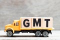 Truck hold block in word GMT abbreviation of Greenwich Mean Time on wood background