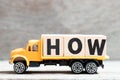 Truck hold block in word how on wood background