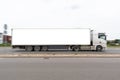 Truck with a large white semi-trailer. Free white space for text, advertising and logo on the trailer. Motion blur Royalty Free Stock Photo