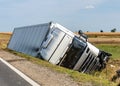 The truck lies in a side ditch after the road accident.