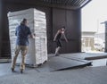 Truck loading and shipping. Male workers are loading the goods in cardboard boxes on a truck.