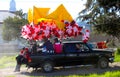 Truck with many Santa claus balloons