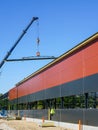 Truck mounted crane with a telescoping boom at constructing a metal carcas of a new building