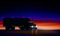 Truck moves on highway in night. Classic big rig semi truck headlights dry van in dark on night road on colorful starry sky