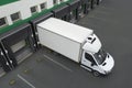Truck near loading dock of warehouse outdoors, aerial view. Logistics center Royalty Free Stock Photo