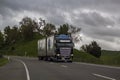 Truck passes on road on cloudy day