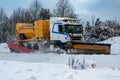 Truck plowing snow and putting salt on road