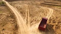 Truck rides on sand quarry road. Scene. Top view of dump truck driving on yellow dirt road in countryside. Large trucks