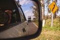 Truck on a road reflected in a rear view mirror Royalty Free Stock Photo