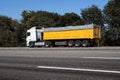 Truck on the road, side view, empty space on a yellow container - concept of cargo transportation, trucking industry Royalty Free Stock Photo