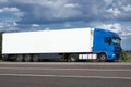 Truck on road with white blank container, blue sky, cargo transportation concept Royalty Free Stock Photo