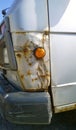 Truck with rust, corrosion, defects and scratches, close up. Car body repair. Sheet metal corrosion. Old steel surface. Vehicle bo