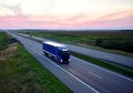 Truck with semi-trailer driving along highway on the sunset background. Goods delivery by roads. Services and Transport logistics Royalty Free Stock Photo