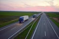 Truck with semi-trailer driving along highway on the sunset background. Goods delivery by roads. Services and Transport logistics Royalty Free Stock Photo
