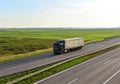 Truck with semi-trailer driving along highway on the sunset background. Goods delivery by roads. Services and Transport logistics Royalty Free Stock Photo