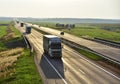 Truck with semi-trailer driving along highway on the sunset background. Goods delivery by roads. Services and Transport logistics Royalty Free Stock Photo