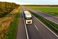 Truck with semi-trailer driving along highway on the sunset background. Goods delivery by roads. Services and Transport logistics Royalty Free Stock Photo