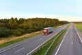 Truck with semi-trailer driving along highway on the sunset background. Goods delivery by roads. Services and Transport logistics Royalty Free Stock Photo