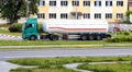 A truck with a semi-trailer tank for the transport of gasoline and diesel drains fuel at a gas station. Dangerous goods Royalty Free Stock Photo