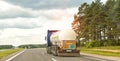 A truck with a semi-trailer tank transports a dangerous cargo of liquefied gas. The concept of transportation of flammable goods. Royalty Free Stock Photo