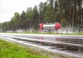 A truck with a semi-trailer tanker transports a dangerous cargo of fuel on a motorway slippery in the rain, industry