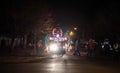 Truck with Seuss monster lights up nighttime street as people pr