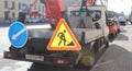 Truck sign roadworks. There are warning signs on the back of the truck.