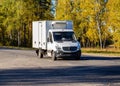 A truck with a small carrying capacity and a refrigerated booth transport perishable goods to another city. articulated lorry