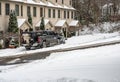 Truck with snow plow attachment blade clearing residential street