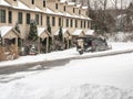 Truck with snow plow attachment blade clearing residential street