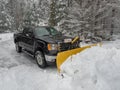 Truck snow plow clearing a parking lot after storm Royalty Free Stock Photo