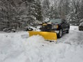 Truck snow plow clearing a parking lot after storm Royalty Free Stock Photo