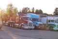 Truck stop. A row of trucks. End of the day, the setting sun Royalty Free Stock Photo