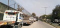 Truck and tailors standing inside road safely