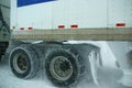 Truck tires spinning on highway during snowstorm