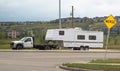 A truck towing a camper RV trailer during summer Royalty Free Stock Photo