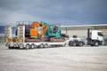 Truck towing Hydraulic Excavators on Float Trailer Royalty Free Stock Photo