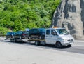 Truck towing a platform on which vehicles are loaded. Car transport.