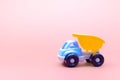 Truck toy model car on pink background, space for text Royalty Free Stock Photo