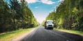 Truck, Tractor Unit, Prime Mover, Traction Unit In Motion On Country Road Through Forest, Freeway. Cloudy Sky Above Royalty Free Stock Photo