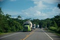 Trucks on a rural Colombian highway in tropical climate