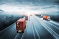 Truck transport with red container on highway road at sunset, motion blur effect, logistics import export background Royalty Free Stock Photo