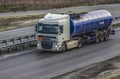 Truck for transportation delivers cargo in a tank on a multi-lane highway Royalty Free Stock Photo