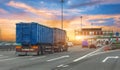 Truck transportation with separate trailer blue color drives among other cars heavy traffic along city highway during sunset sky