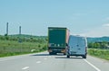 Truck transporting goods in traffic. It engages in a dangerous overtaking.