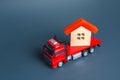 Truck transporting a house. Delivery services to another house. A moving company. Transportation of real estate. Resettlement