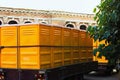 Truck transporting mobile or portable toilets. Yellow cabines of bio toilets in the city center. WC transporting. Portable bio-