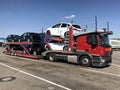 Truck transporting new Mercedes Benz automobiles