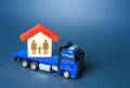 The truck transports the house with the family. Home moving transport company. Relocation for work. Mobility and flexibility of Royalty Free Stock Photo