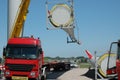 Truck is unloading cargo next to another rotor blade for the assembly of a windmill